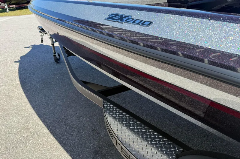 Slide: The Image of 2023 Skeeter ZX200 boat with sleek design and metallic finish on a trailer. - 5