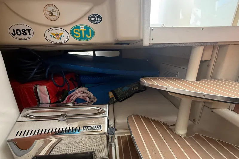 Slide: The Image of Interior of 2007 Wellcraft 290 Coastal boat with storage, stickers, and wooden steps. - 12