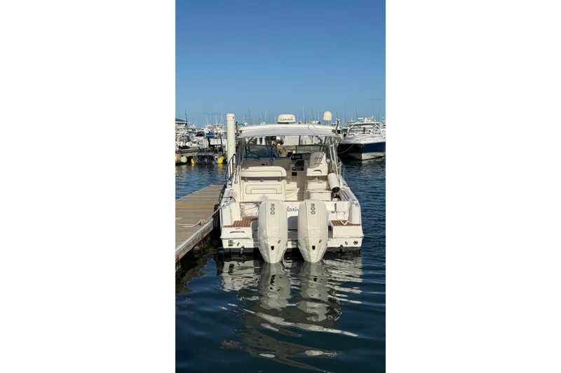 Slide: The Image of 2007 Wellcraft 290 Coastal boat docked at marina, rear view with twin engines. - 3