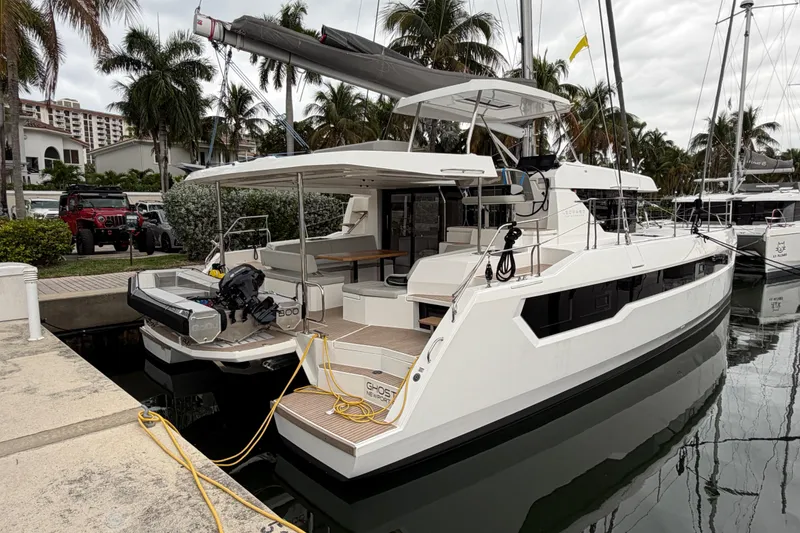 Slide: The Image of 2025 Leopard 46 catamaran docked, featuring solar panels and sleek design. - 2