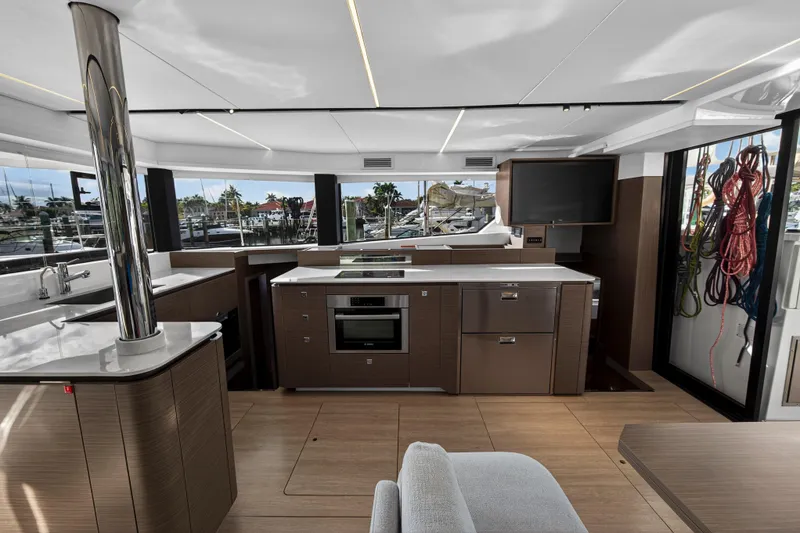 Slide: The Image of Luxurious interior of 2025 Leopard 46 yacht featuring modern kitchen and panoramic windows. - 25
