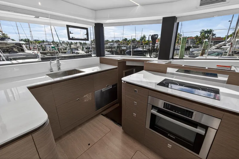 Slide: The Image of Modern kitchen interior on Leopard 46 yacht, 2025 model, featuring sleek appliances and marina view. - 28