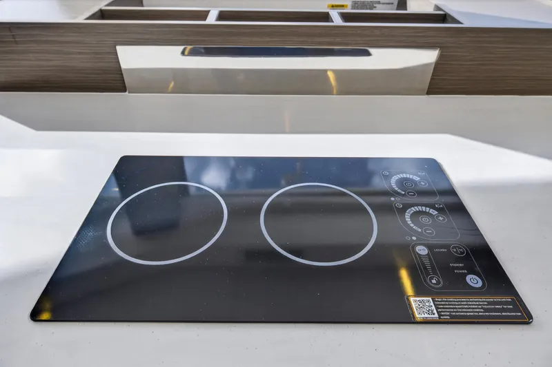 Slide: The Image of Modern induction cooktop on Leopard 46 yacht, 2025 model, featuring sleek design and digital controls. - 30