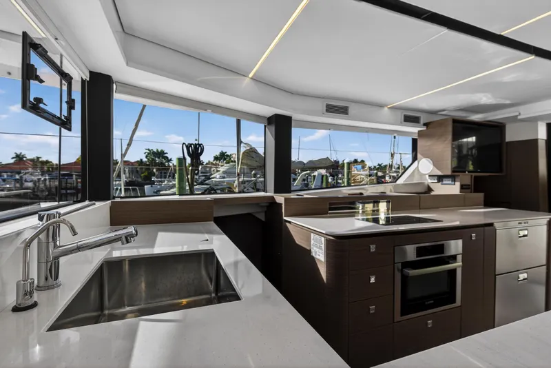 Slide: The Image of Modern kitchen interior on 2025 Leopard 46 yacht, featuring sleek design and marina view. - 31