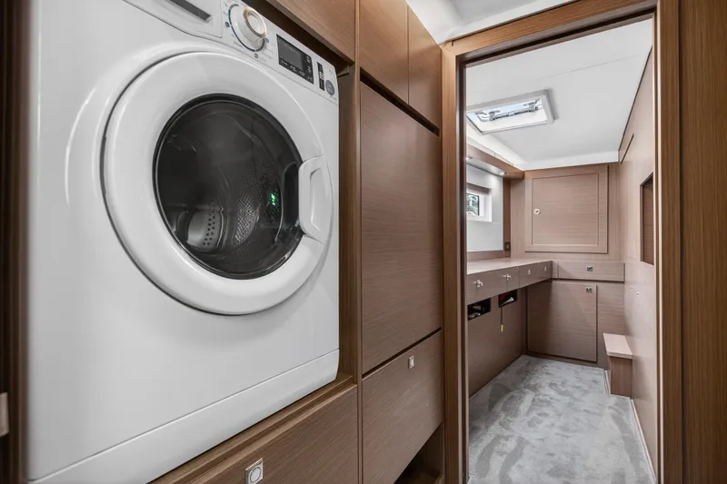 Slide: The Image of Laundry area in 2025 Leopard 46 yacht with modern washer and wooden cabinetry. - 41