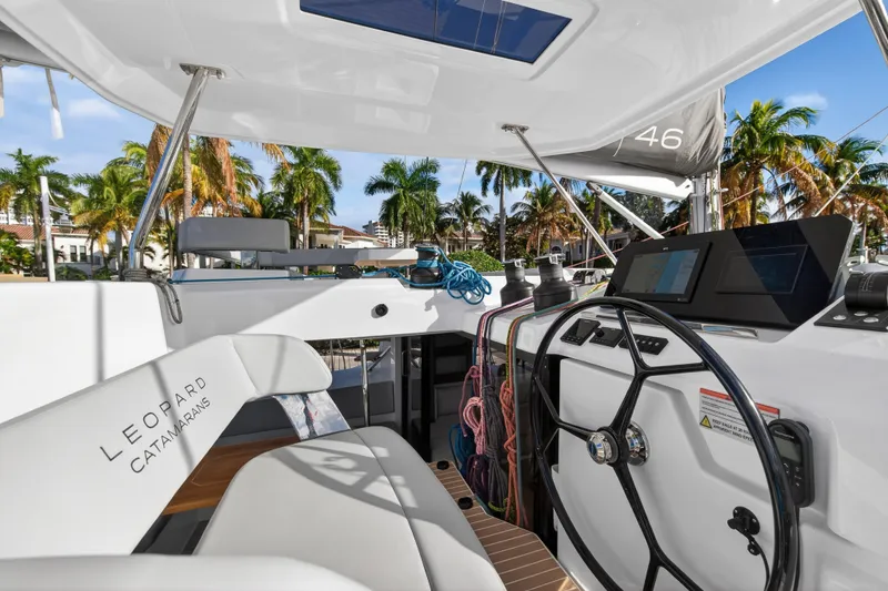 Slide: The Image of Modern Leopard 46 catamaran cockpit with steering wheel, ropes, and navigation screens, 2025 model. - 71