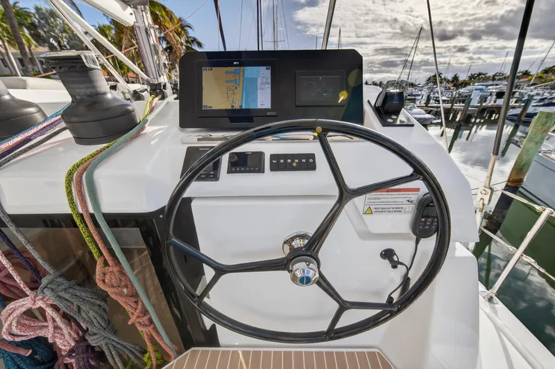 Slide: The Image of Steering wheel and navigation system on 2025 Leopard 46 yacht, docked at marina. - 72