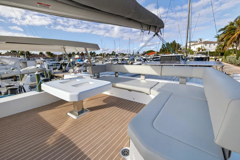 Slide: The Image of Luxurious 2025 Leopard 46 yacht with spacious deck seating in a marina setting. - 78