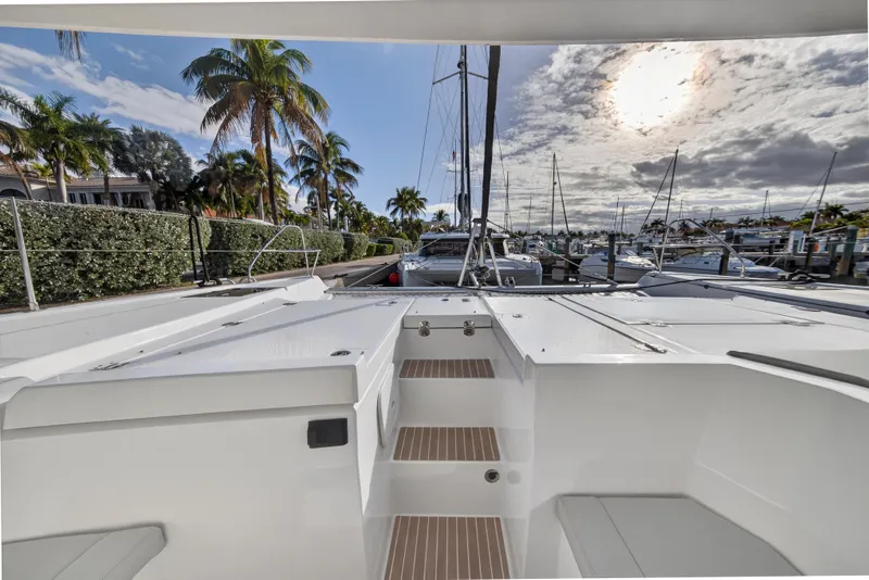 Slide: The Image of 2025 Leopard 46 yacht docked at marina, surrounded by palm trees and sailboats. - 83