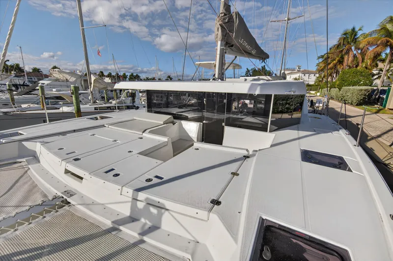 Slide: The Image of 2025 Leopard 46 yacht docked, showcasing sleek design and spacious deck under a clear sky. - 94