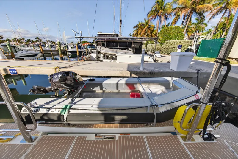Slide: The Image of Docked Leopard 46 boat, 2025 model, with outboard motor in a sunny marina setting. - 96