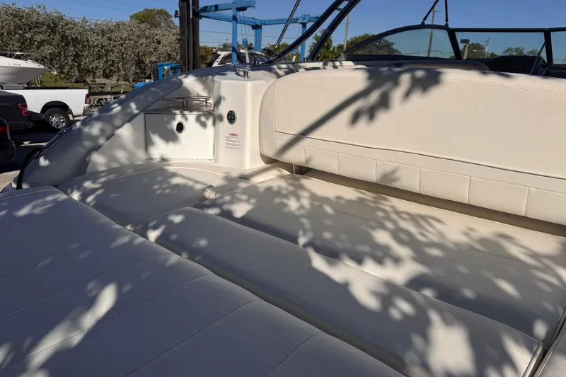 Slide: The Image of 2010 Cobalt 323 boat interior with white leather seating and shadow patterns. - 10