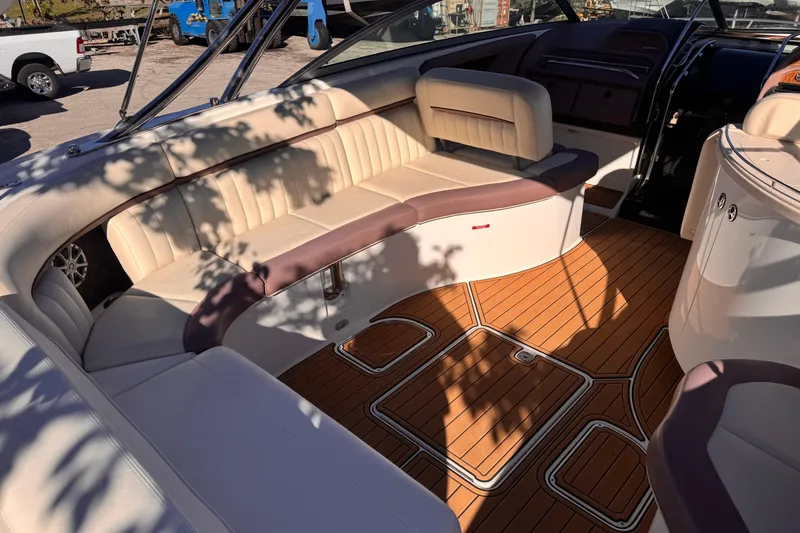 Slide: The Image of Luxurious interior of a 2010 Cobalt 323 boat with plush seating and wooden flooring. - 11