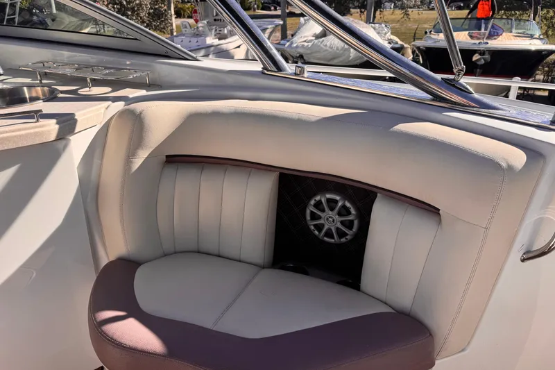Slide: The Image of 2010 Cobalt 323 boat interior with cushioned seating and speaker detail. - 12
