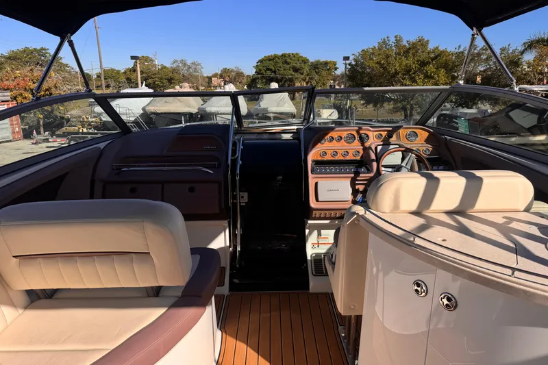Slide: The Image of Interior of a 2010 Cobalt 323 boat with luxurious seating and control panel. - 13