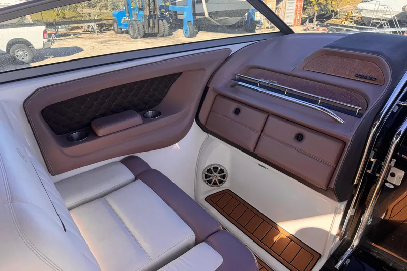 Slide: The Image of Interior of 2010 Cobalt 323 boat with brown leather seating and storage compartments. - 16