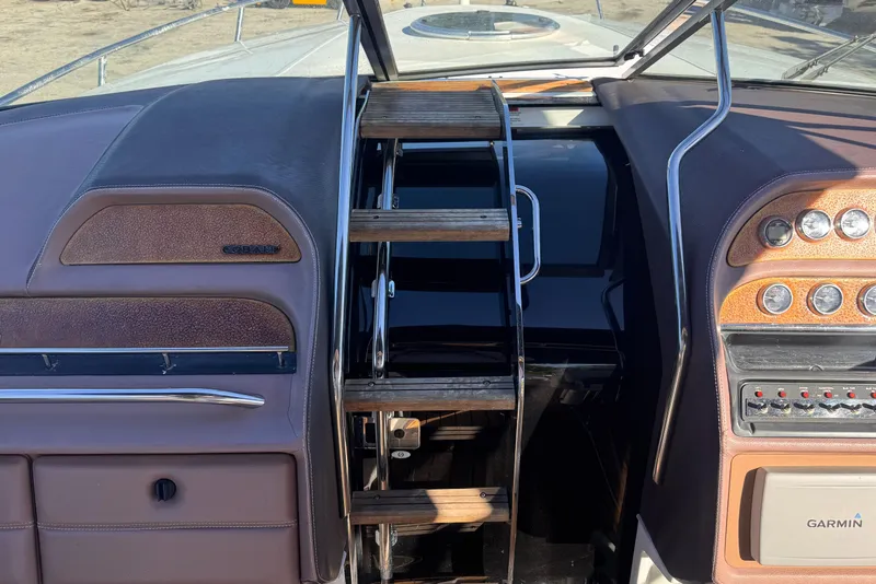 Slide: The Image of 2010 Cobalt 323 boat dashboard with wooden steps and Garmin navigation system. - 20