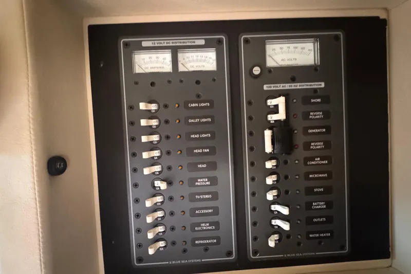 Slide: The Image of Electrical control panel in a 2010 Cobalt 323 boat, featuring DC and AC distribution. - 21
