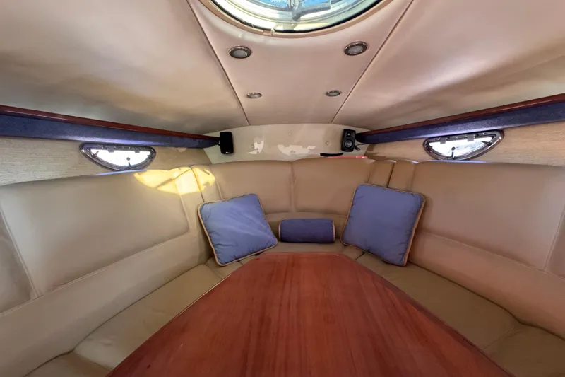 Slide: The Image of Interior of 2010 Cobalt 323 boat with beige seating and blue cushions. - 22