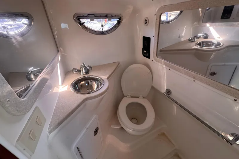 Slide: The Image of Compact bathroom in 2010 Cobalt 323 boat with sink, toilet, and mirror. - 23