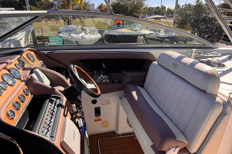 Slide: The Image of Interior of a 2010 Cobalt 323 boat with leather seating and control panel. - 5