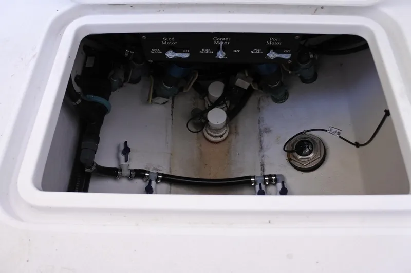 Slide: The Image of Engine compartment of a 2022 Conch 33 boat, showing valves and wiring. - 11