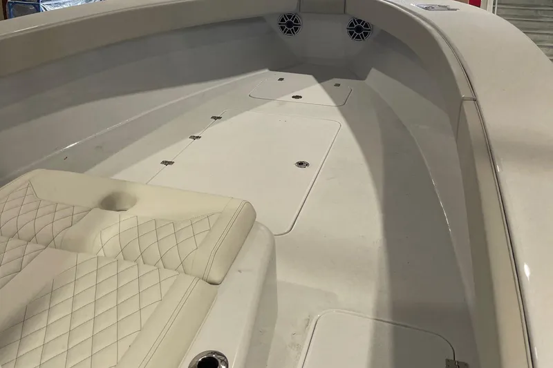 Slide: The Image of 2022 Conch 33 boat interior with cushioned seating and storage compartments. - 4