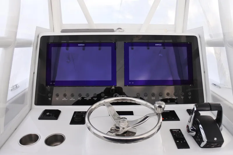 Slide: The Image of Helm of 2022 Conch 33 boat with dual Simrad displays and steering wheel. - 6