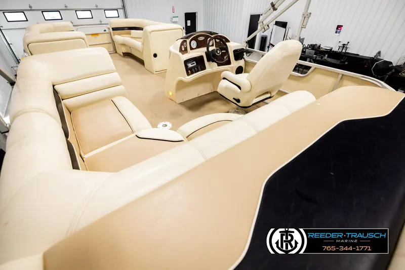 Slide: The Image of Interior view of 2004 AquaPatio 220 RE pontoon boat with beige seating. - 11