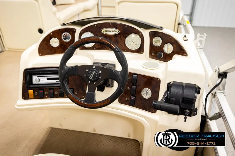 Slide: The Image of 2004 AquaPatio 220 RE boat dashboard with steering wheel and control panel. - 27