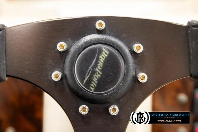 Slide: The Image of Steering wheel of 2004 AquaPatio 220 RE boat with logo and bolts. - 29