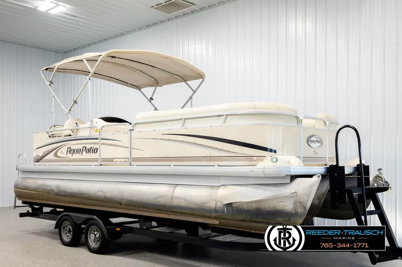 Slide: The Image of 2004 AquaPatio 220 RE pontoon boat on trailer in indoor storage facility. - 3