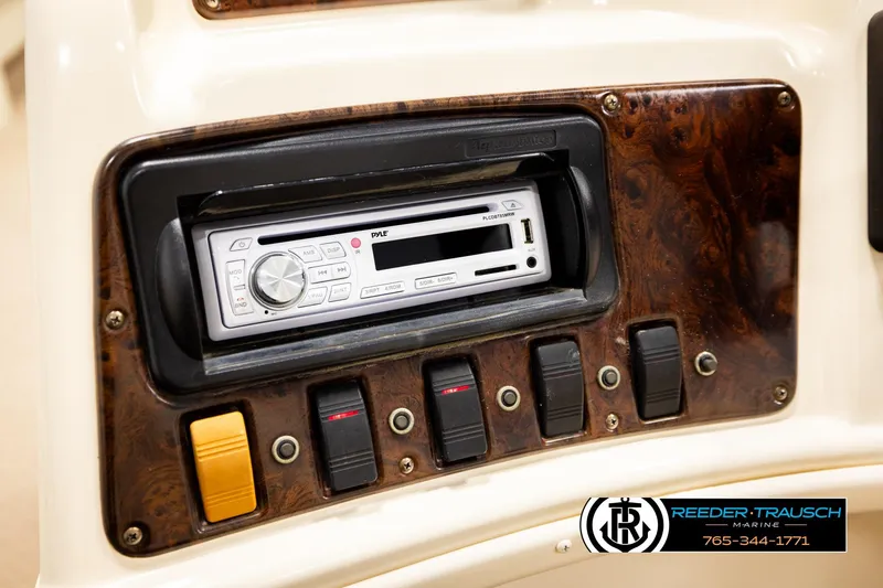 Slide: The Image of Dashboard of 2004 AquaPatio 220 RE with Pyle stereo system and control switches. - 30