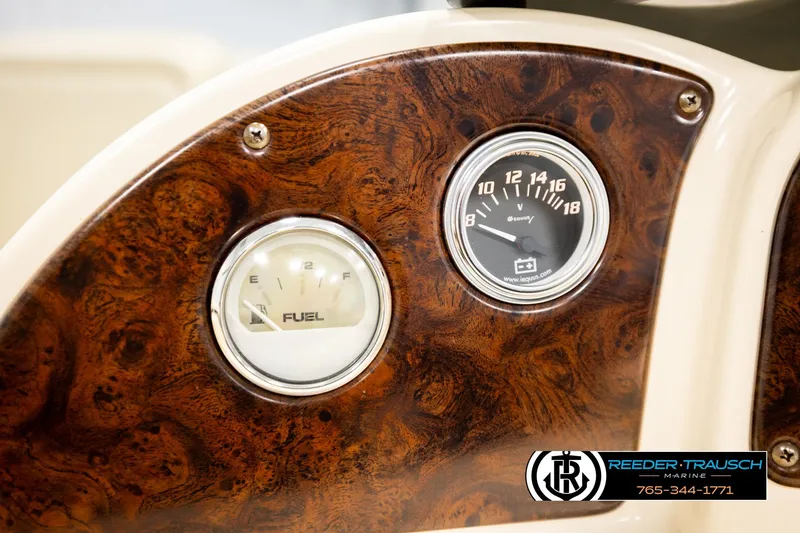 Slide: The Image of Dashboard of 2004 AquaPatio 220 RE boat with fuel and voltage gauges. - 31