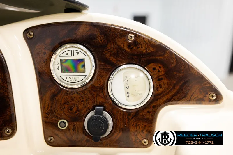 Slide: The Image of Control panel of 2004 AquaPatio 220 RE boat with wood finish and gauges. - 33