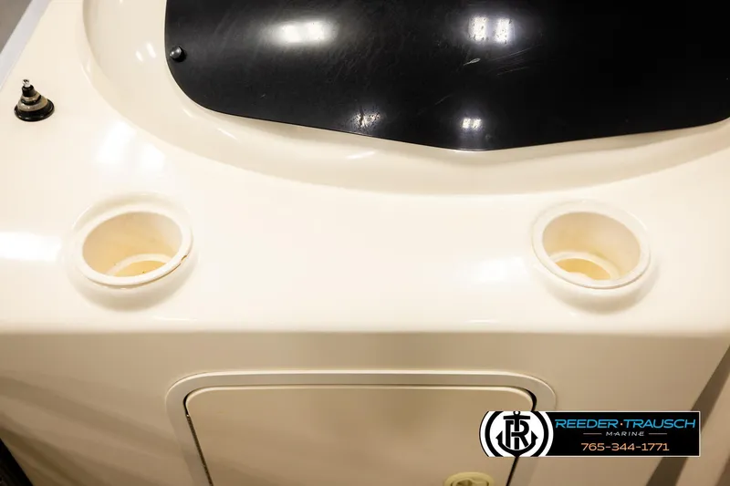 Slide: The Image of 2004 AquaPatio 220 RE boat dashboard with cup holders and control panel. - 41