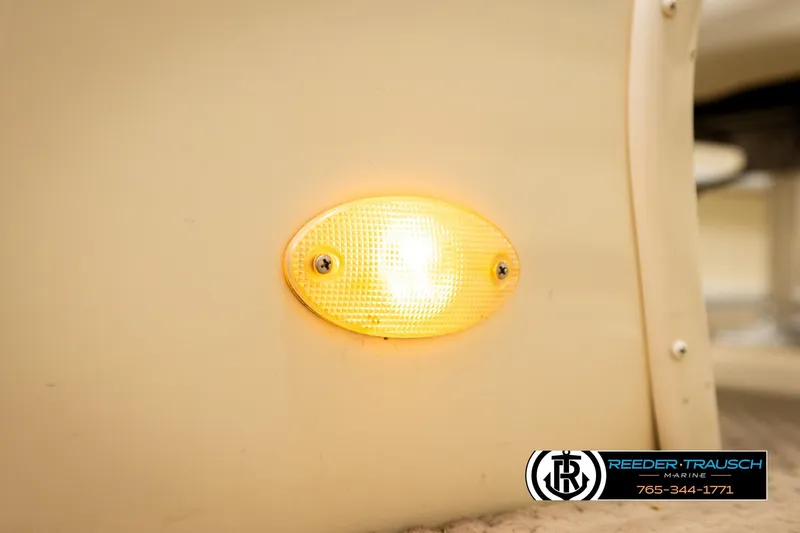 Slide: The Image of Close-up of a 2004 AquaPatio 220 RE boat's illuminated side marker light. - 42