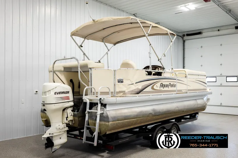 Slide: The Image of 2004 AquaPatio 220 RE pontoon boat with Evinrude motor in indoor storage. - 6