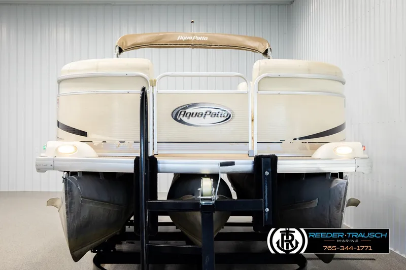 Slide: The Image of 2004 AquaPatio 220 RE pontoon boat in indoor storage, front view. - 8