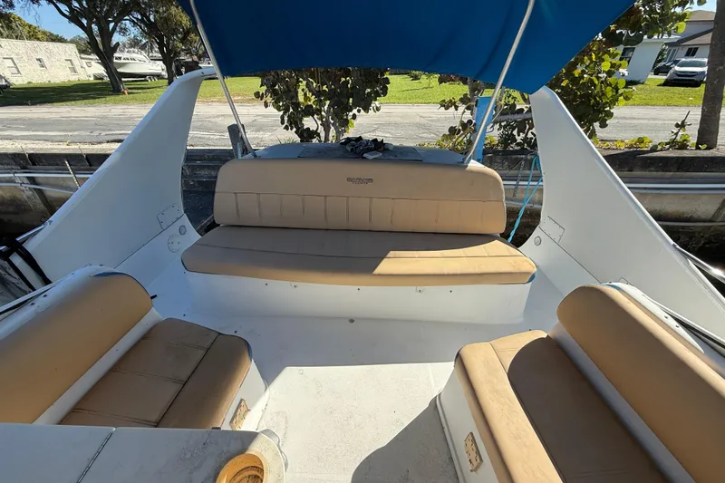 Slide: The Image of 2000 Carver 350 Mariner boat interior with beige seating and blue canopy. - 6
