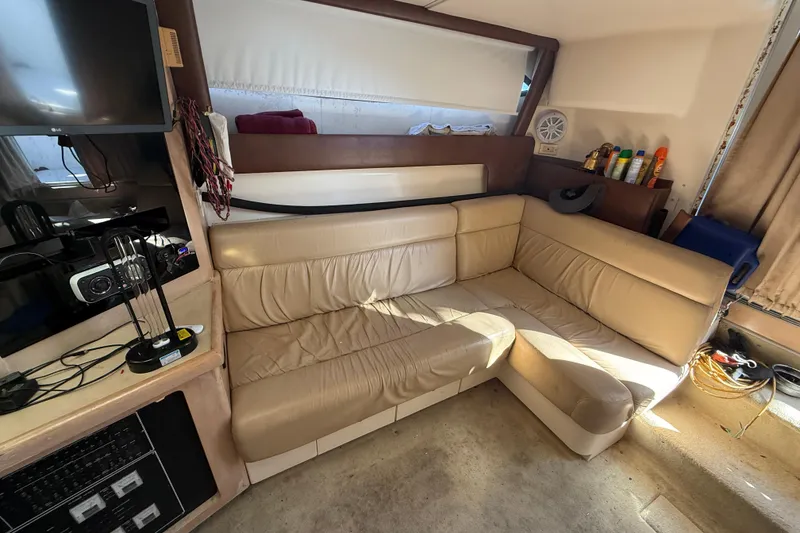 Slide: The Image of Interior of 2000 Carver 350 Mariner with beige leather seating and entertainment setup. - 7