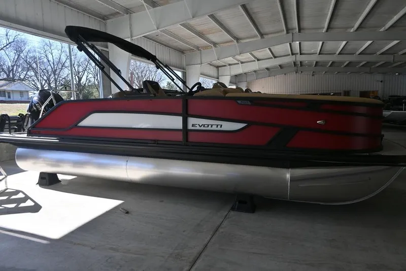 The Image of 2026 Evotti 521CS pontoon boat in a covered storage area. - 1