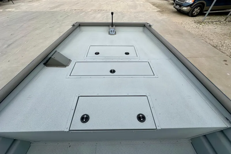 Slide: The Image of 2026 SeaArk 2472 CUB boat deck with storage compartments and control lever. - 11