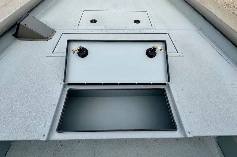 Slide: The Image of 2026 SeaArk 2472 CUB boat deck with open storage compartments. - 12