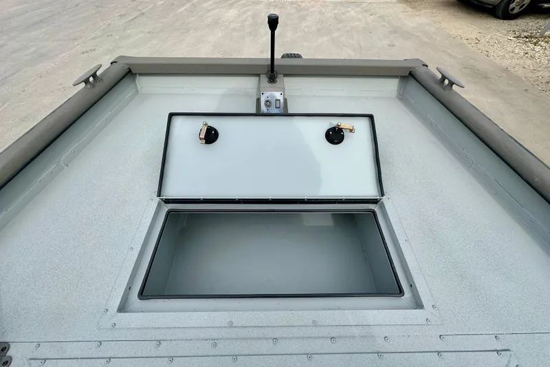 Slide: The Image of 2026 SeaArk 2472 CUB boat with open storage compartment on deck. - 13