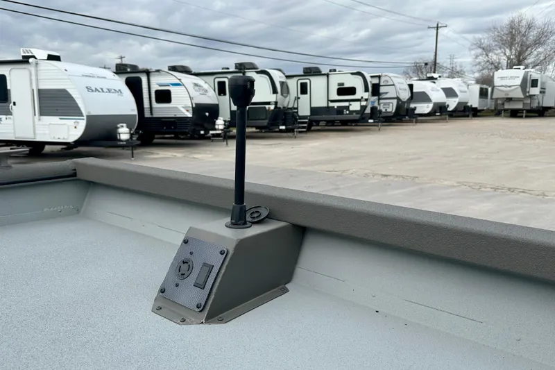 Slide: The Image of 2026 SeaArk 2472 CUB boat interior with RVs in the background. - 14