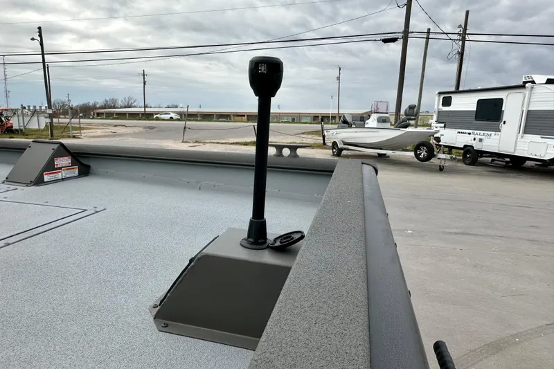 Slide: The Image of 2026 SeaArk 2472 CUB boat deck with equipment, parked near RV and trailer. - 15