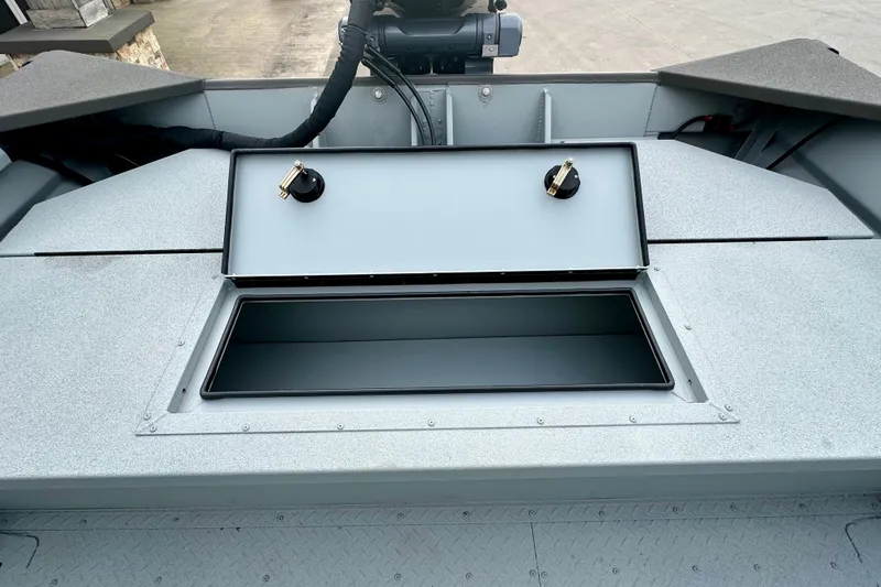 Slide: The Image of 2026 SeaArk 2472 CUB boat storage compartment with open lid, showcasing interior space. - 20