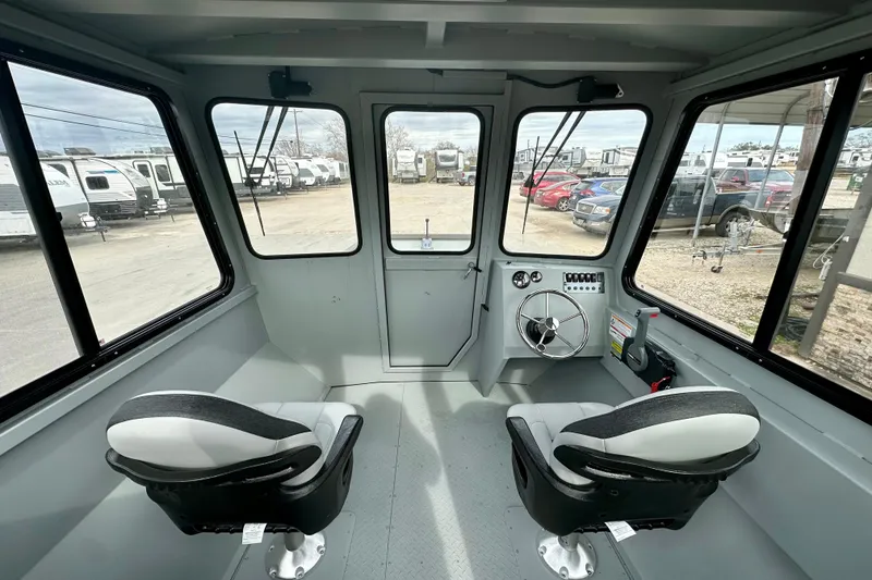 Slide: The Image of Interior of 2026 SeaArk 2472 CUB boat with dual seats and steering console. - 21