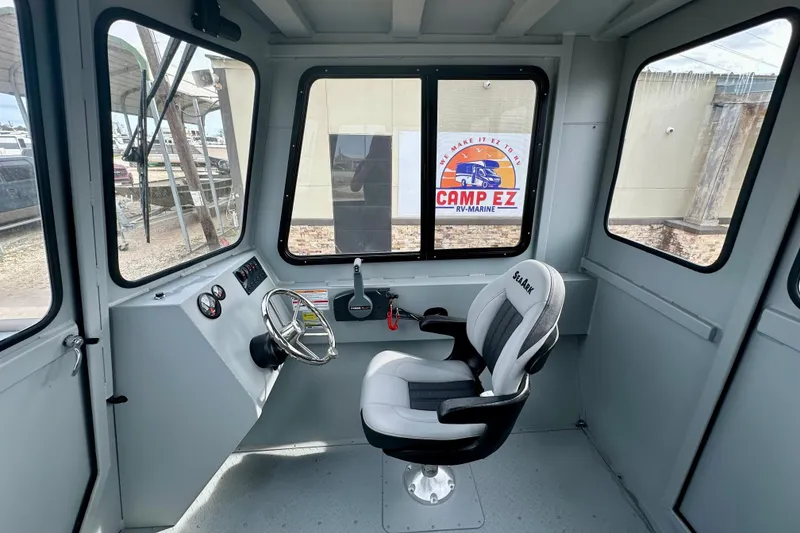 Slide: The Image of Interior of 2026 SeaArk 2472 CUB boat with steering wheel and captain's chair. - 23